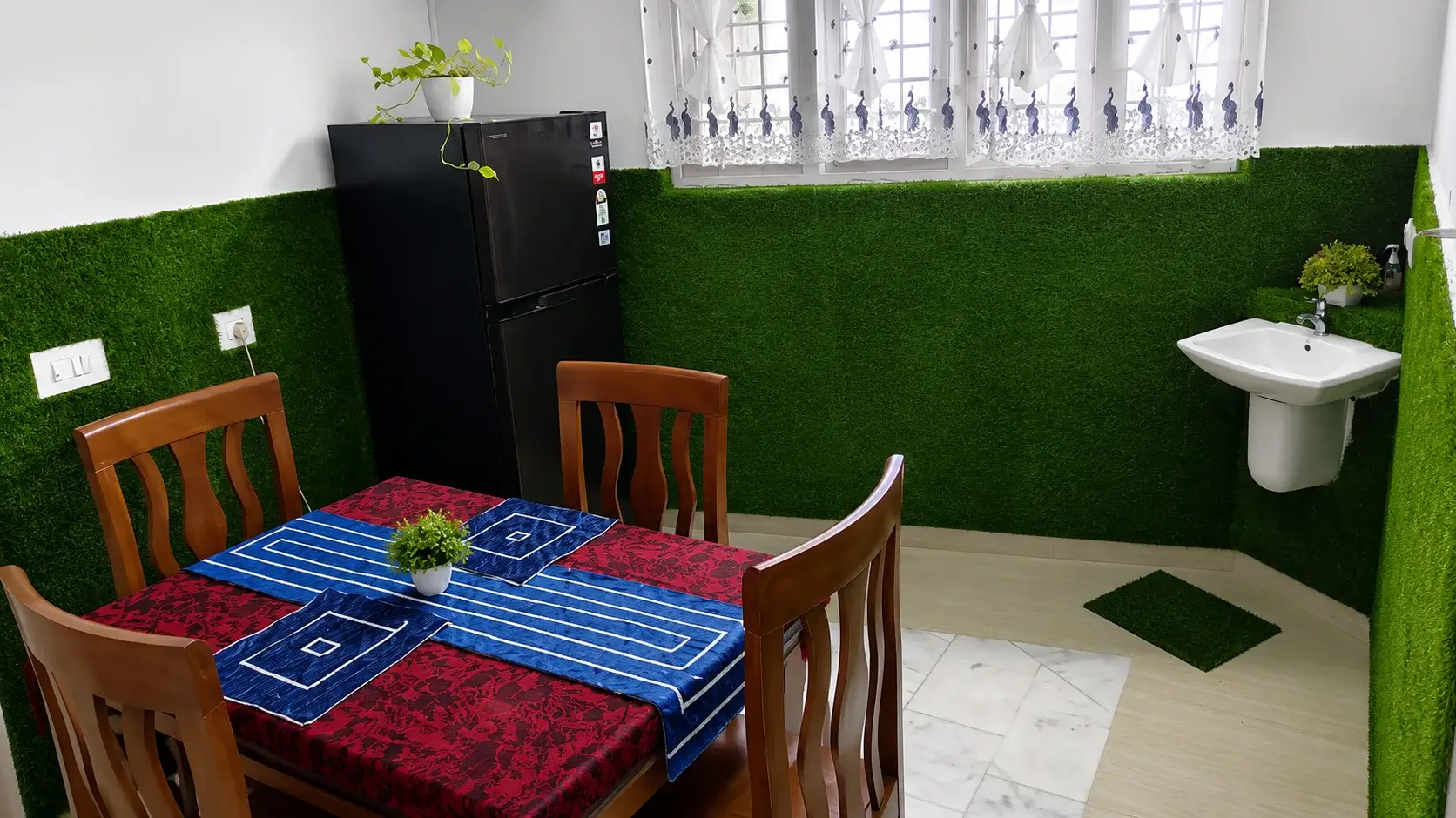 Common dining table and shared refrigerator at Misty Garden Homestay Fort Kochi